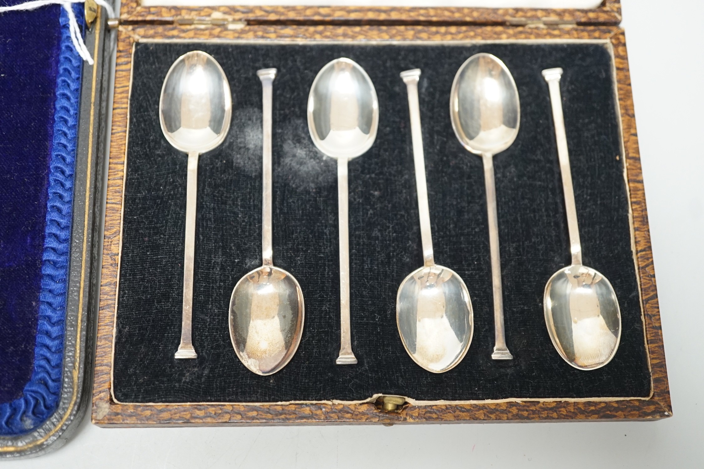 A set of six George V silver seal top coffee spoon, cased, and a pair of George V silver old English pattern fruit spoons, Sheffield, 1916, cased.